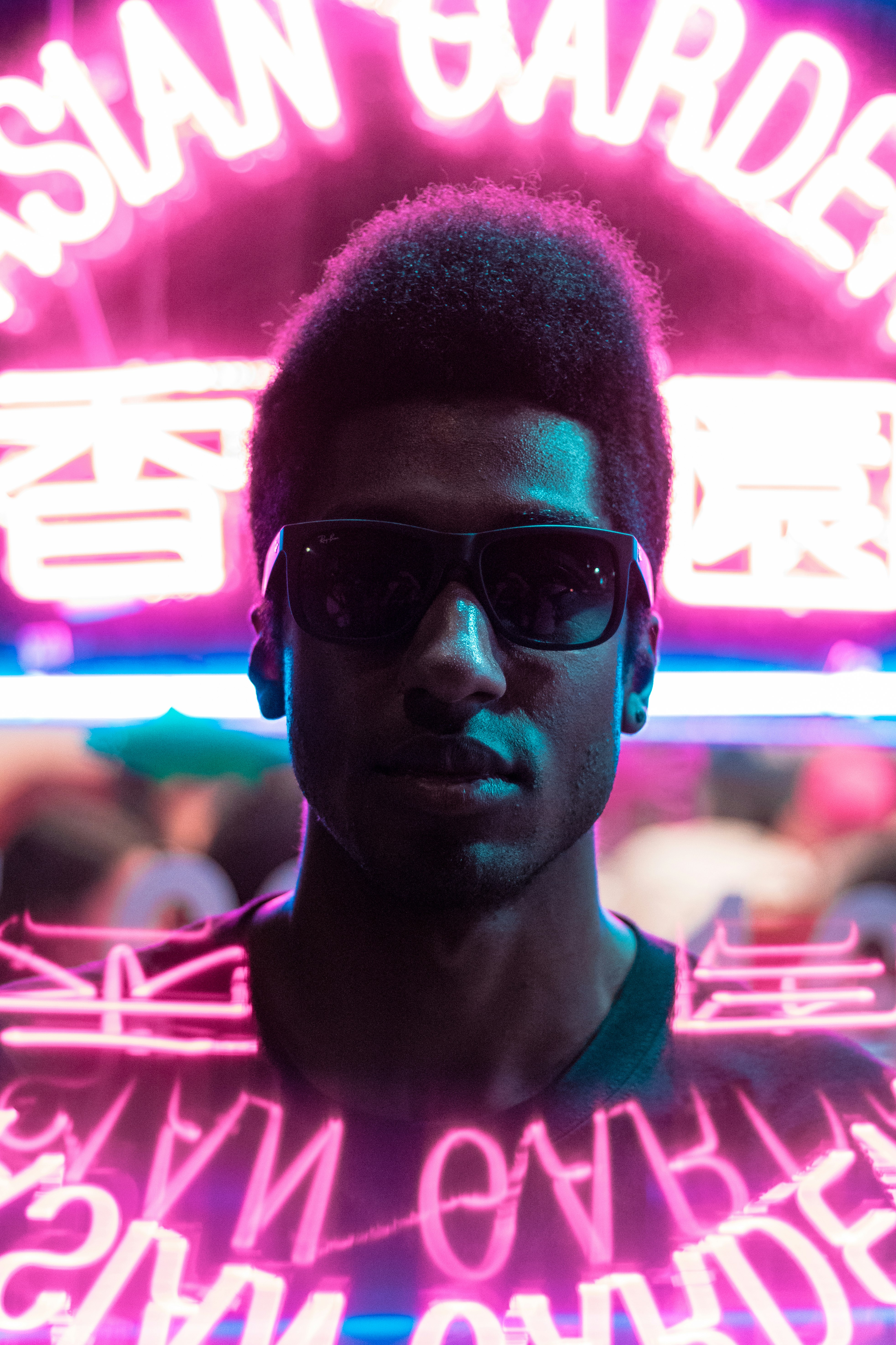 man standing in front of neon signage